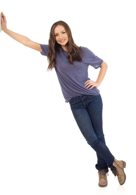 54276600 - smiling girl lean on wall